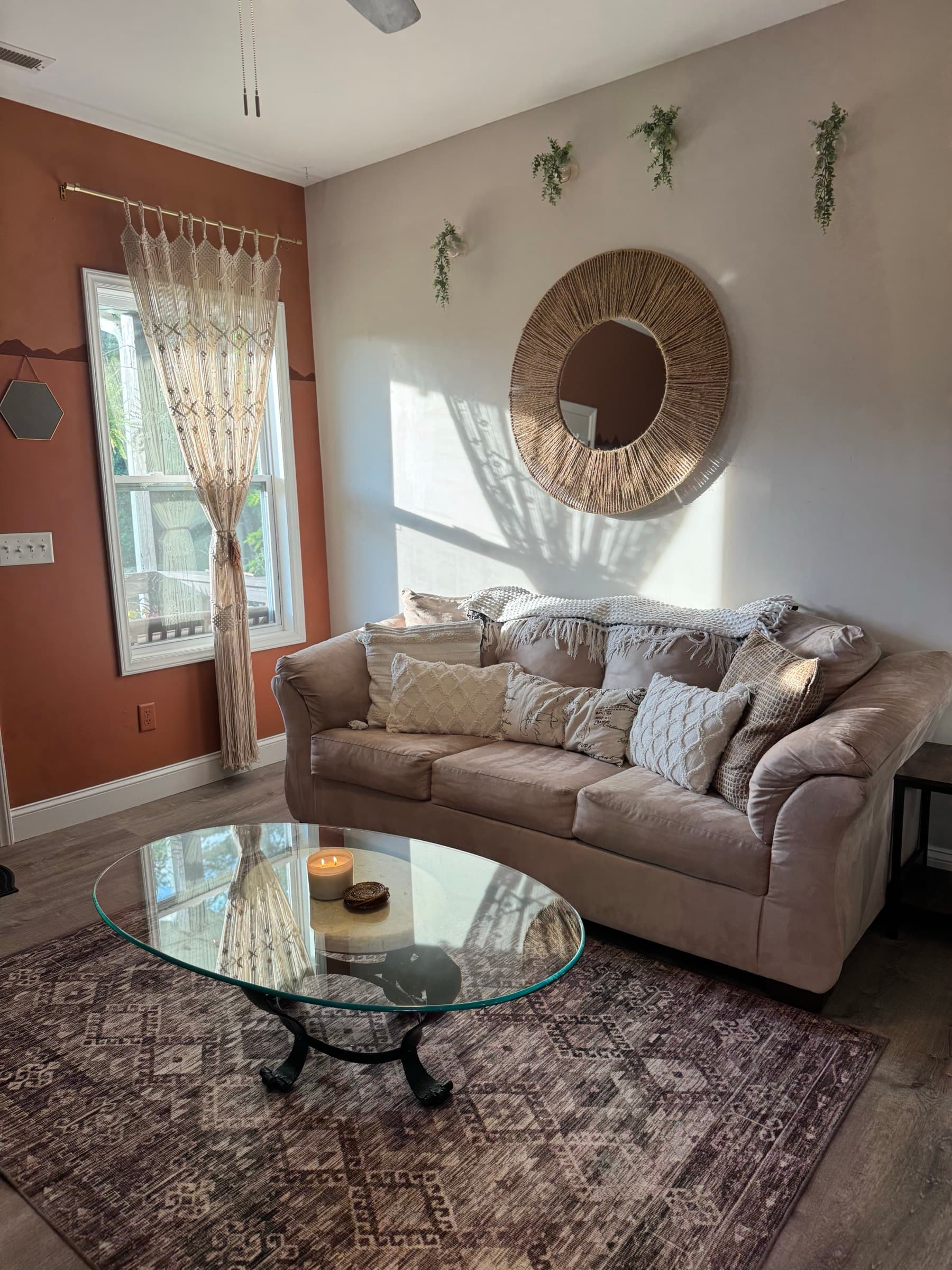 Bright living room sofa with patterned rug and sunlit window
